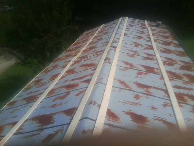 Rusted metal roof panels with new wood purlins before replacement — Storm Damage Roof Repair in Troutville by Roofing Brothers
