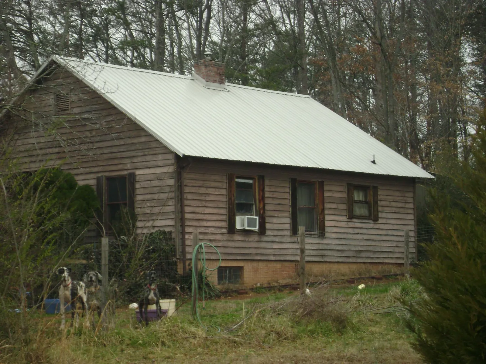 White metal roof on an old wood sided farmhouse, from a Metal Roof Installation job in Troutville